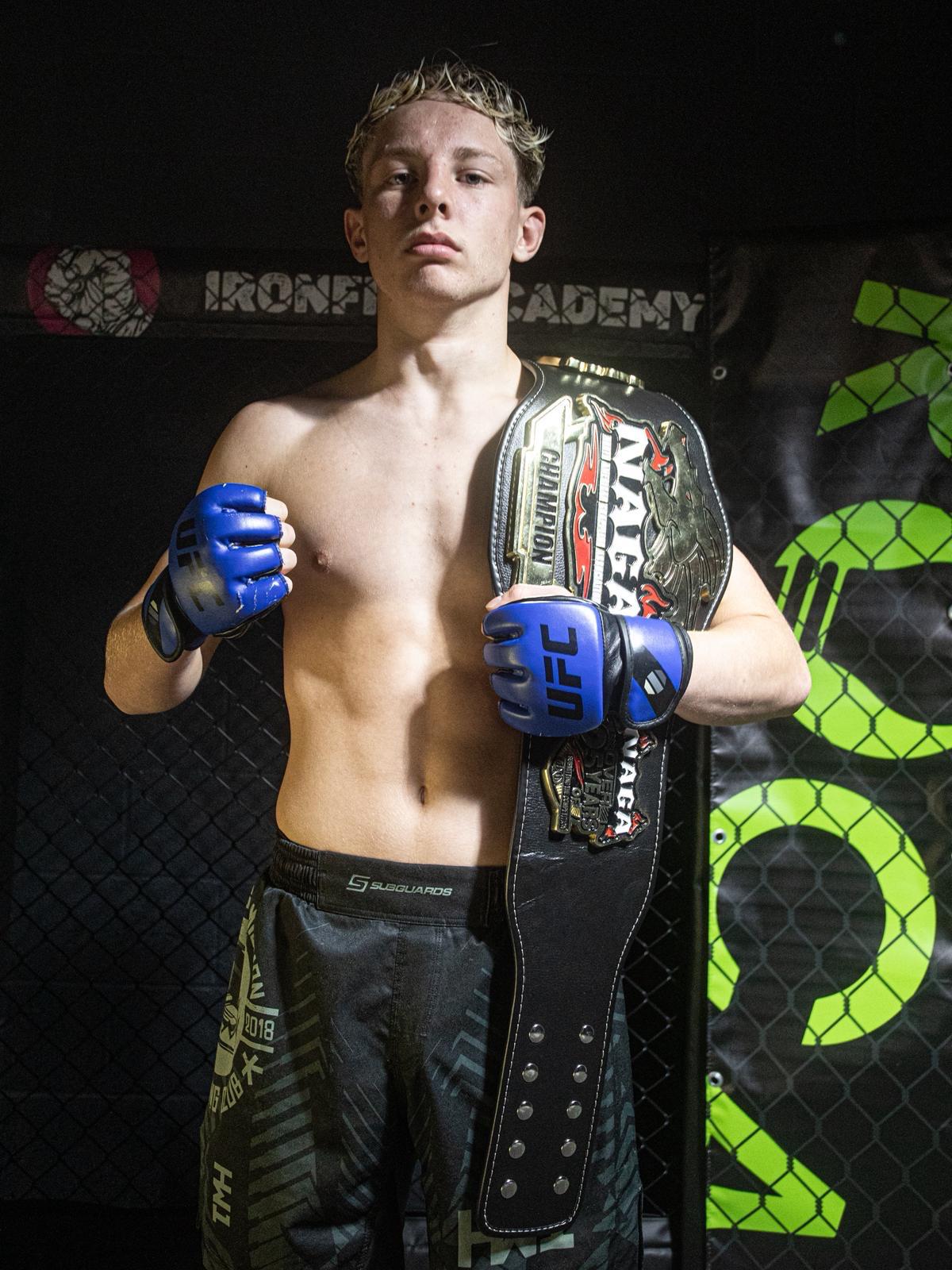 Portrait of elite BJJ, MMA and Judo coach with championship belt